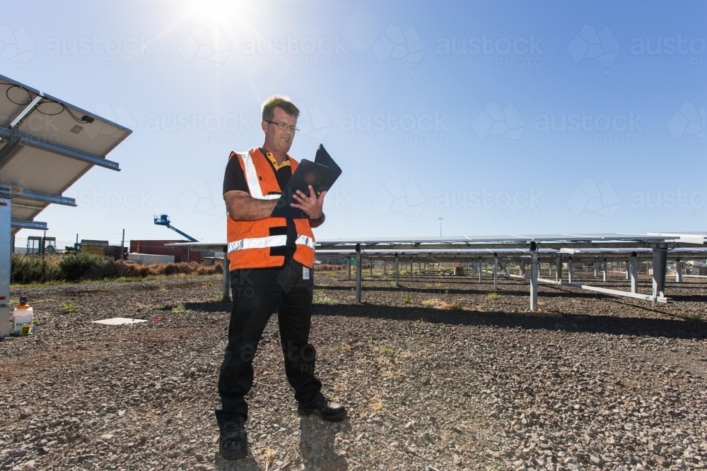 Employee taking notes at a Solar Panel plant - Australian Stock Image