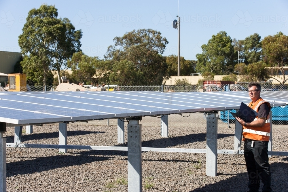 Employee taking notes at a Solar Panel plant - Australian Stock Image