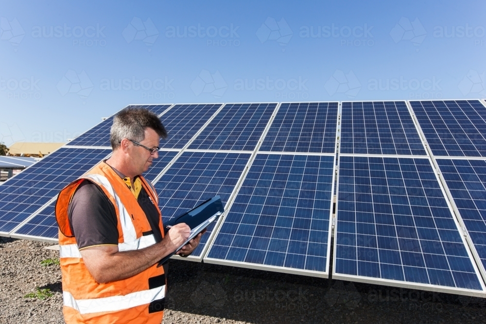 Employee taking notes at Solar Panel plant - Australian Stock Image