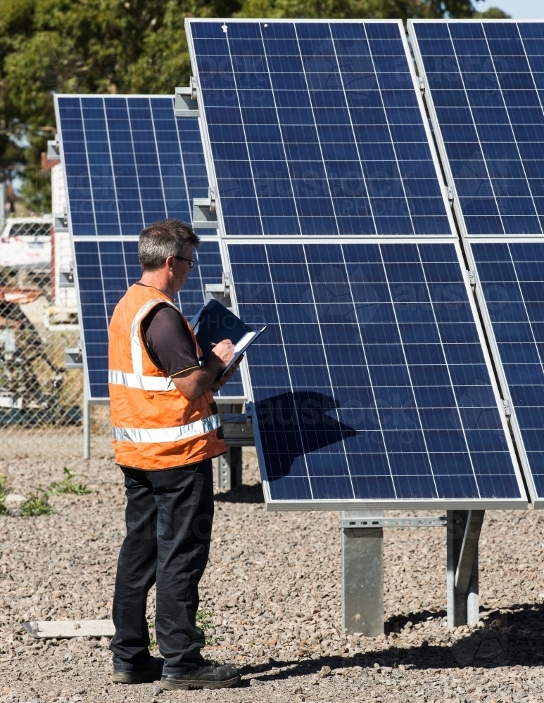 Employee taking notes at Solar Panel plant - Australian Stock Image