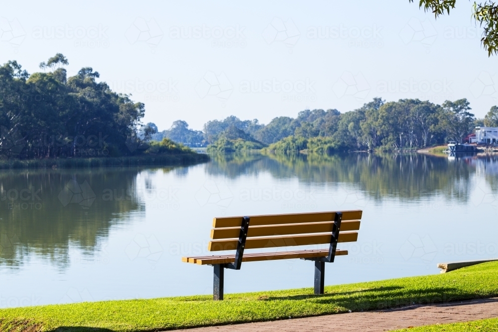 Empty bench overlooking a river - Australian Stock Image