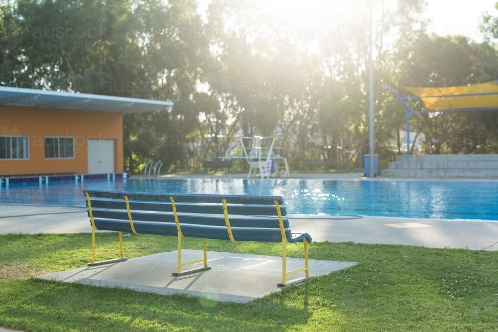 empty bench seat at a public swimming pool - Australian Stock Image