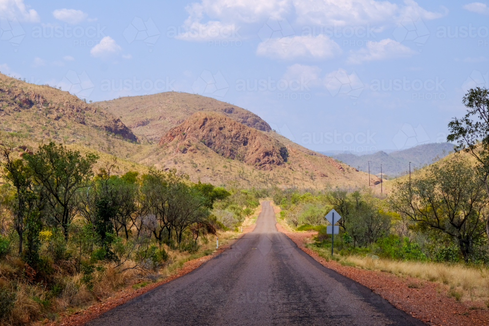 Image of Empty country Road winding into the distant ochre sandstone ...