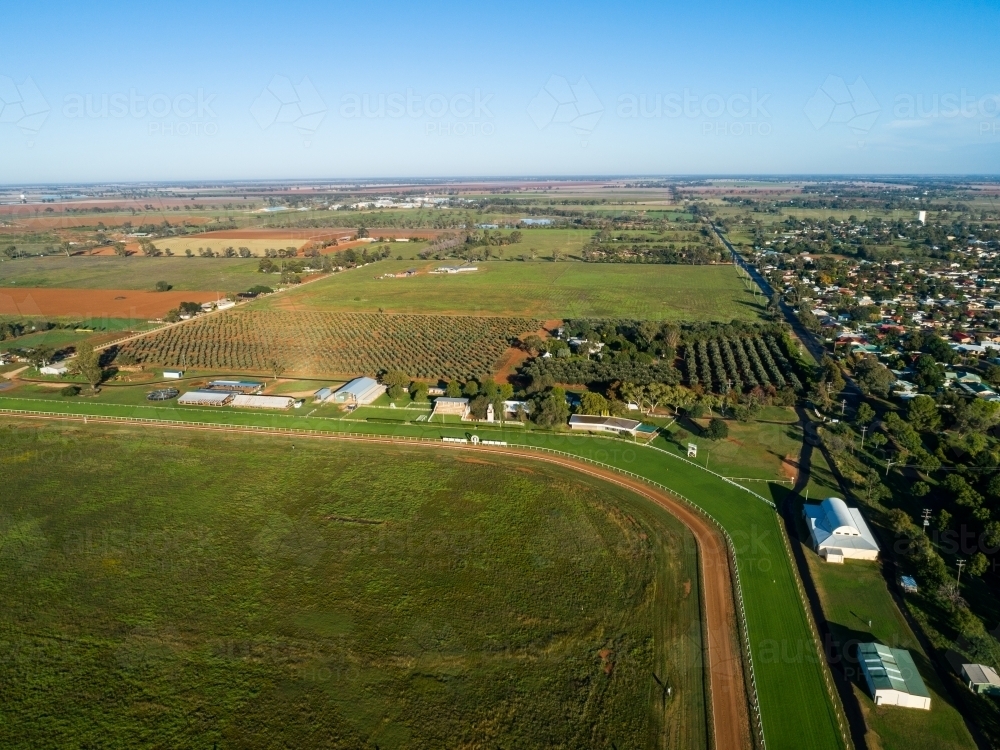 Empty country showground oval and racecourse seen from the air on sunlit day - Australian Stock Image