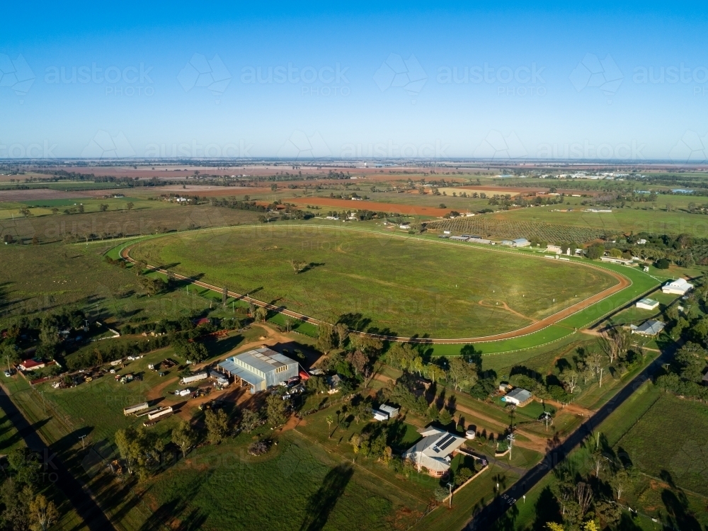 Empty country showground oval and racecourse seen from the air on sunlit day - Australian Stock Image