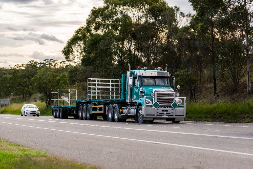 Empty flatbed truck on rural highway road - Australian Stock Image