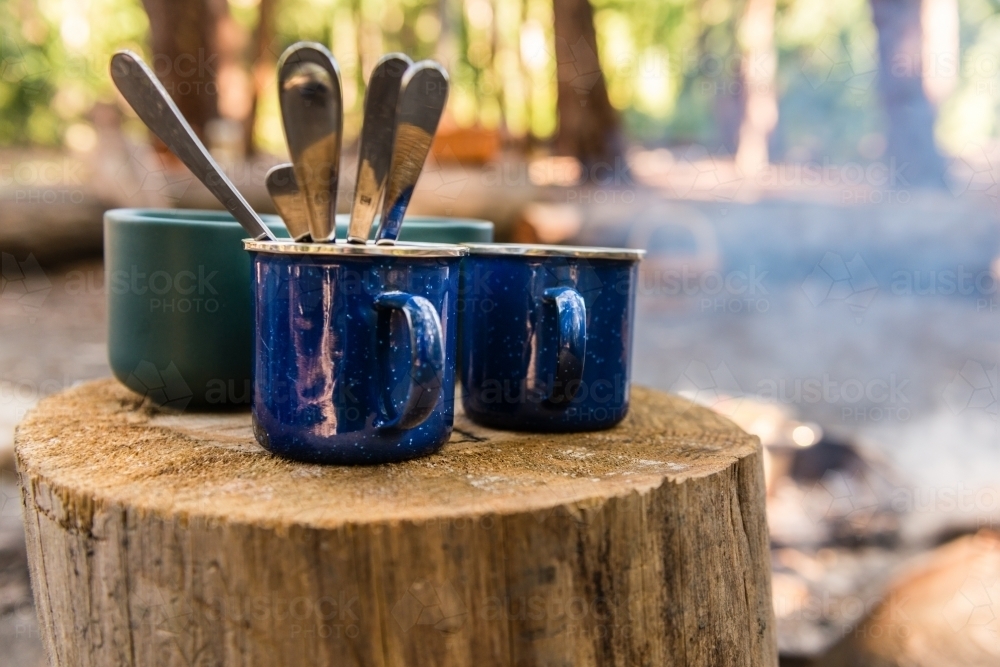 empty mugs by the campfire - Australian Stock Image