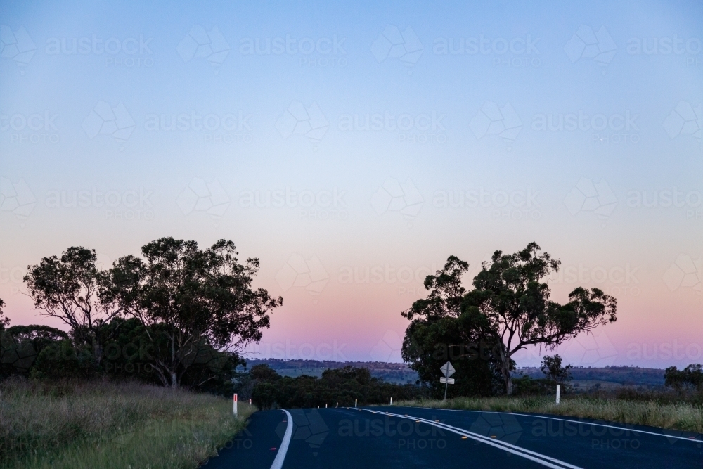 empty rural road at dusk in countryside - Australian Stock Image