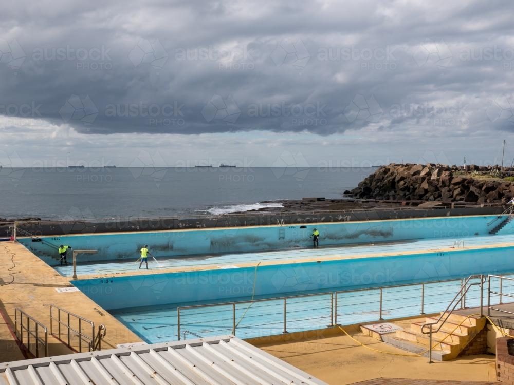 Empty seaside olympic sized swimming pool being cleaned - Australian Stock Image