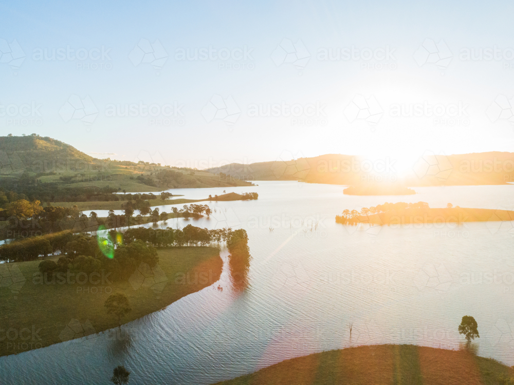 end of the day sunlight over Glennies creek dam water supply seen from aerial view - Australian Stock Image