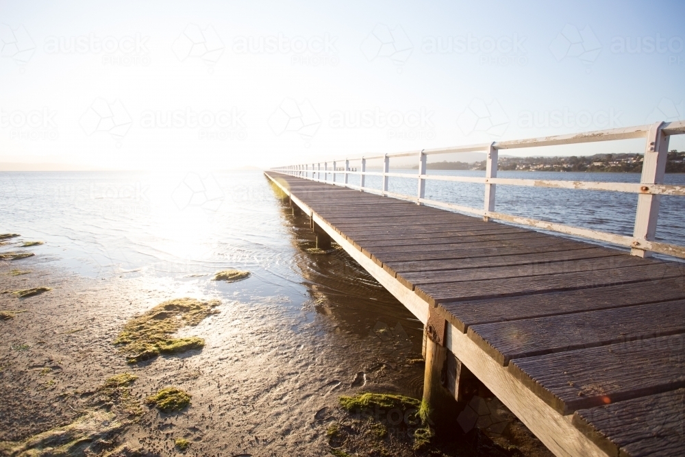 Endless jetty on a lake at sunset - Australian Stock Image