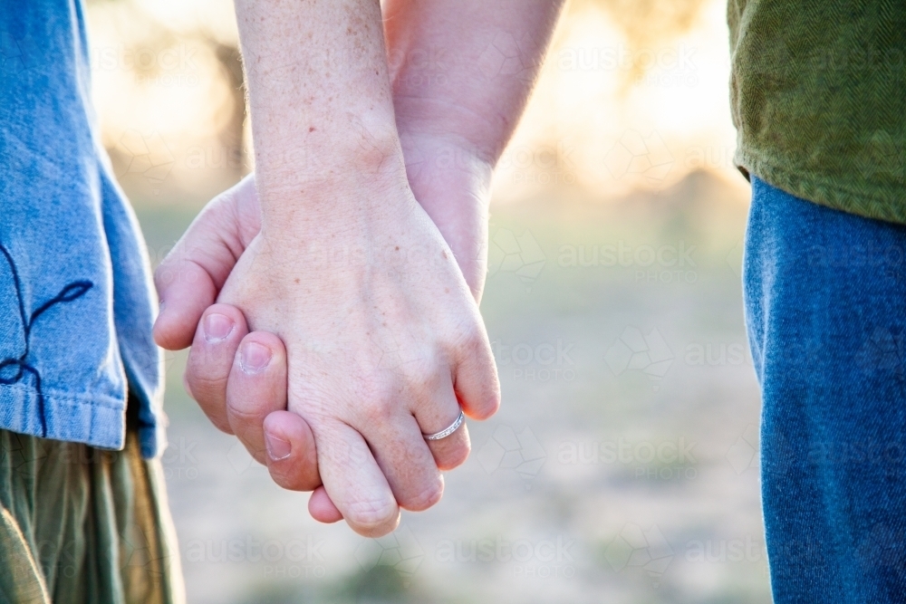 Engaged couple holding hands ring on finger - Australian Stock Image