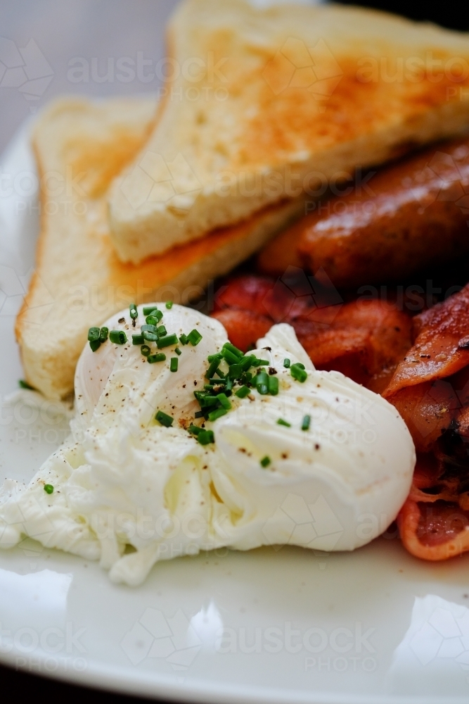 English breakfast of eggs, bacon, sausages and toast - Australian Stock Image