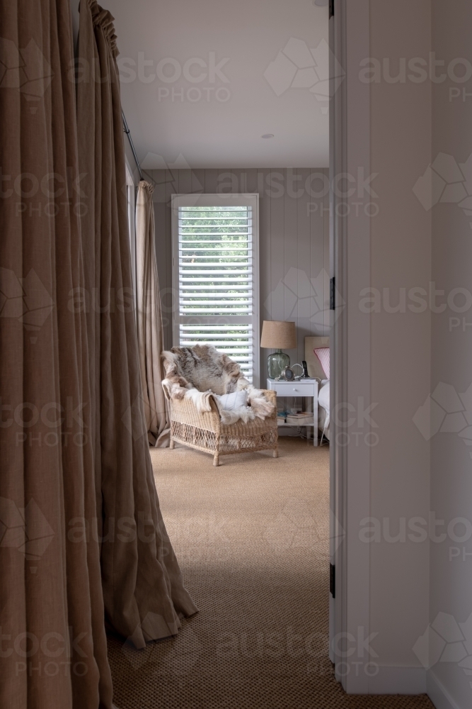 Entrance to Boho styled bedroom with sea grass carpet floor coevering - Australian Stock Image
