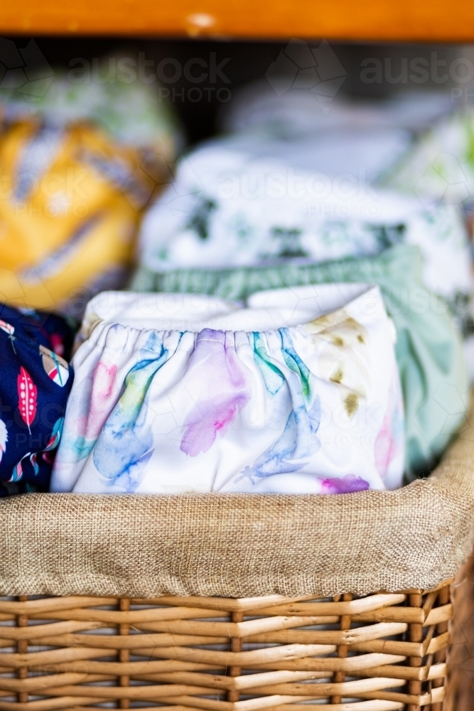 environmentally friendly modern cloth nappy stash of pocket diapers in basket : Austockphoto environmentally friendly modern cloth nappy stash of pocket diapers in basket - Australian Stock Image