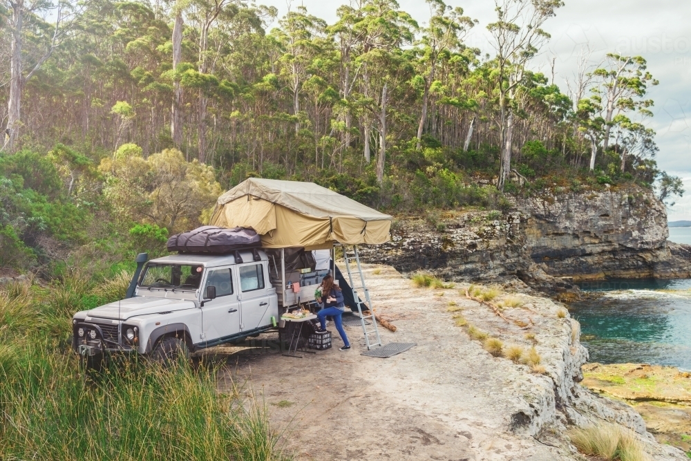 epic campsite on a ledge by the ocean, Bruny Island, Tasmania - Australian Stock Image