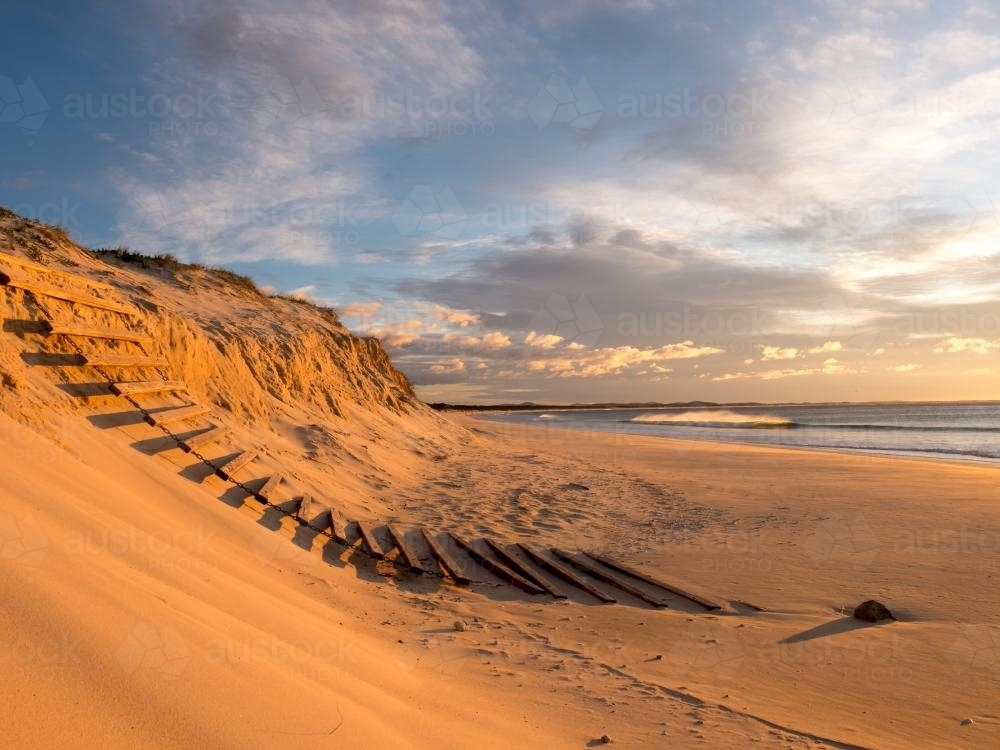 Erosion of beach sand dunes caused by a big storm - Australian Stock Image