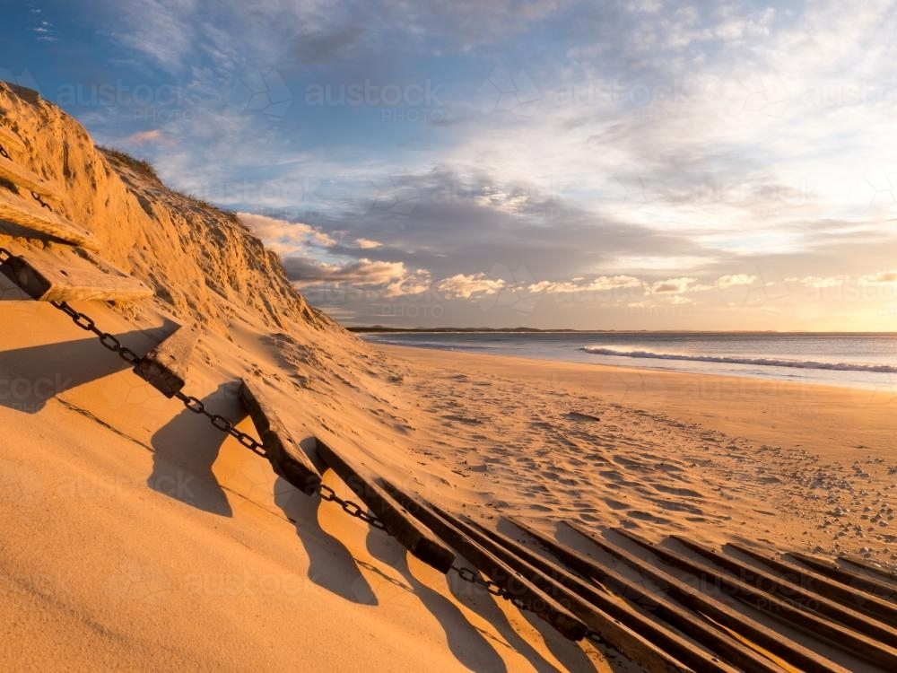 Erosion of beach sand dunes caused by a big storm - Australian Stock Image