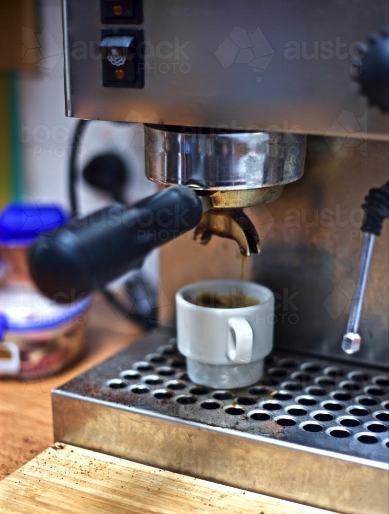 Espresso coming out of a domestic coffee machine - Australian Stock Image