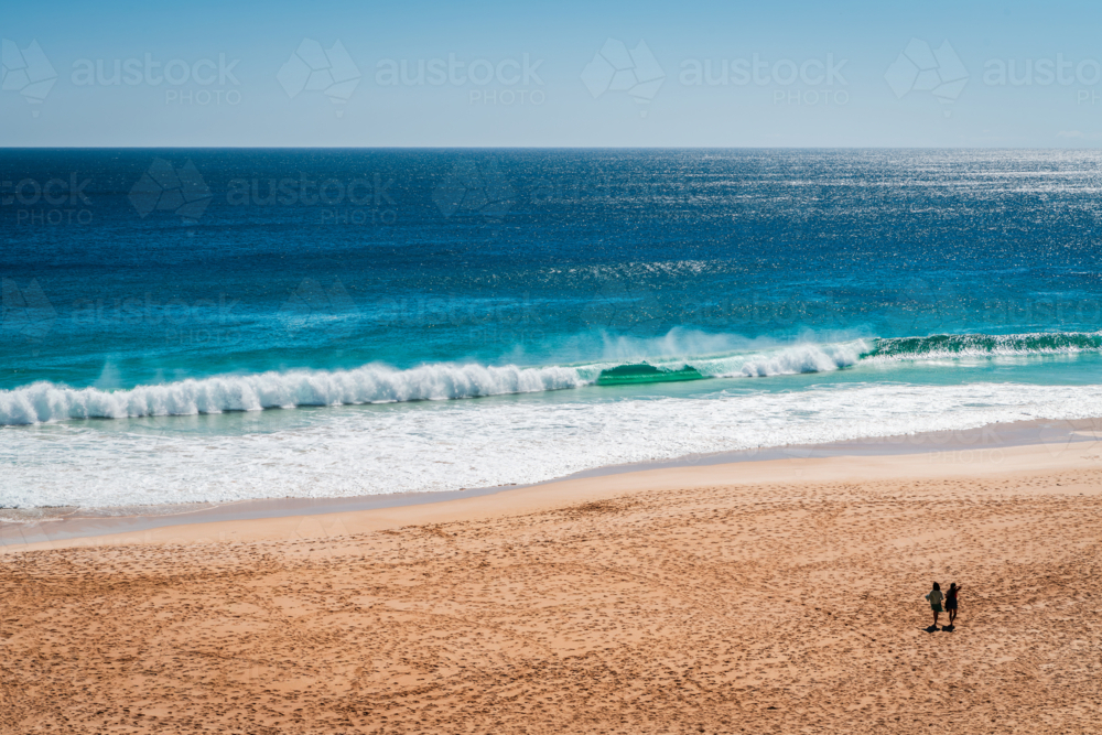 Ethel Wreck Beach with two unidentified women walking along on a bright day, Yorke Peninsula - Australian Stock Image