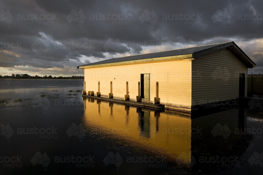Evening sun shining on old boat shed - Australian Stock Image