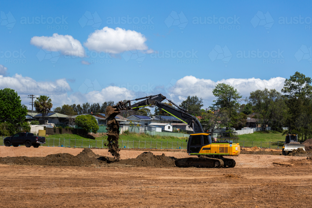 Digging By Compress Image of Excavator digging dirt on construction site with earthmoving ...