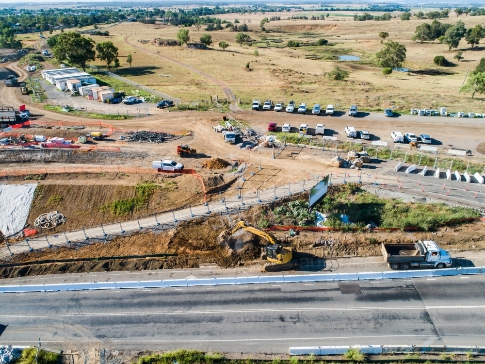 Excavator loading dirt into truck at worksite - Australian Stock Image