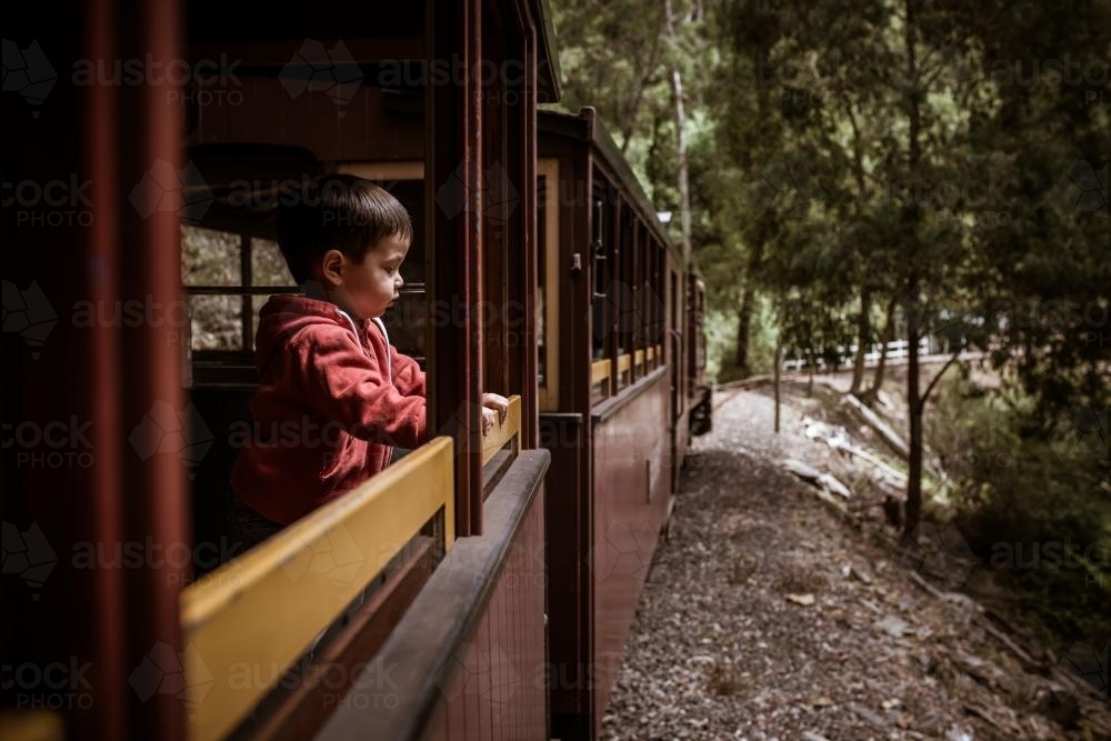 Excited 2 year old mixed race boys cheerfully rides the Walhalla historic train - Australian Stock Image