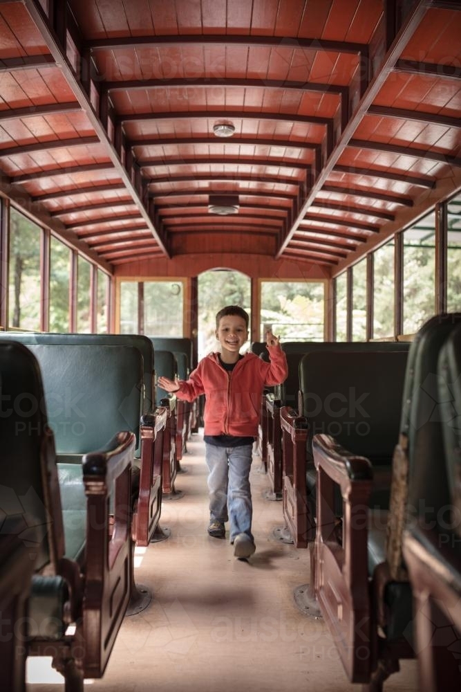 Excited 4 year old mixed race boy cheerfully rides the Walhalla historic train - Australian Stock Image