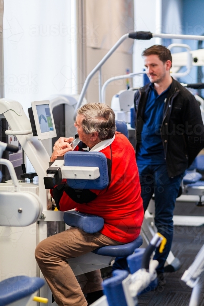 Image of exercise therapy equipment at physiotherapy clinic with man in ...
