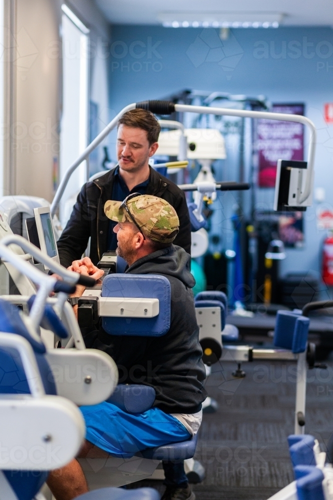 Image of exercise therapy equipment at physiotherapy clinic with man ...