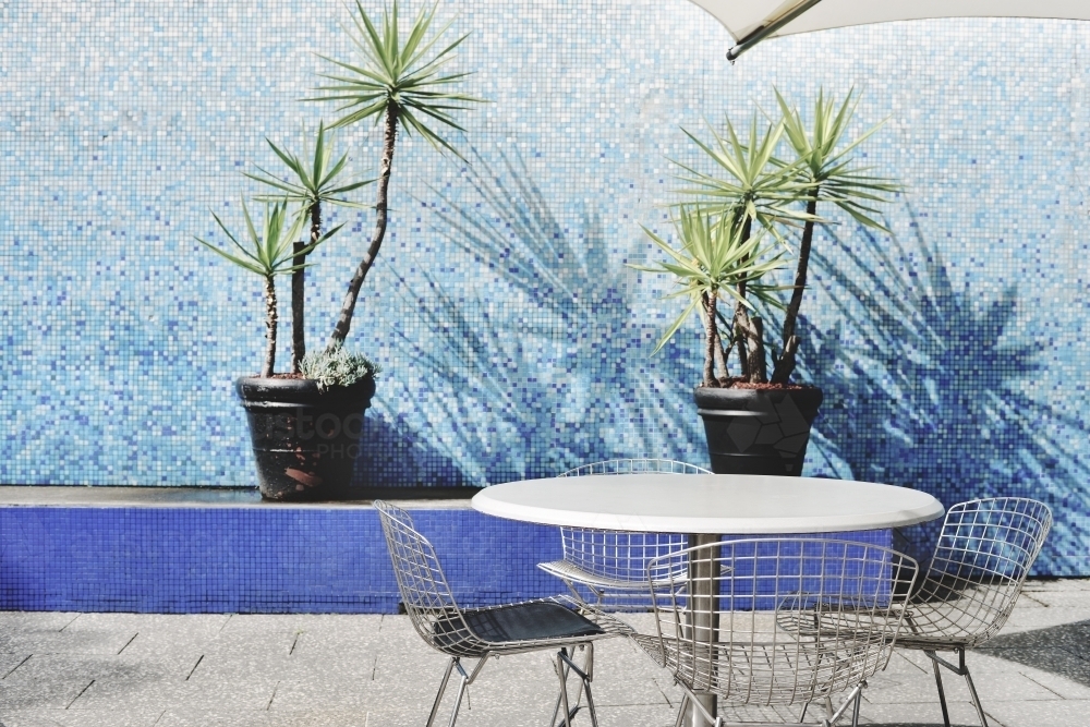 Exterior of table, chairs and plants by pool - Australian Stock Image
