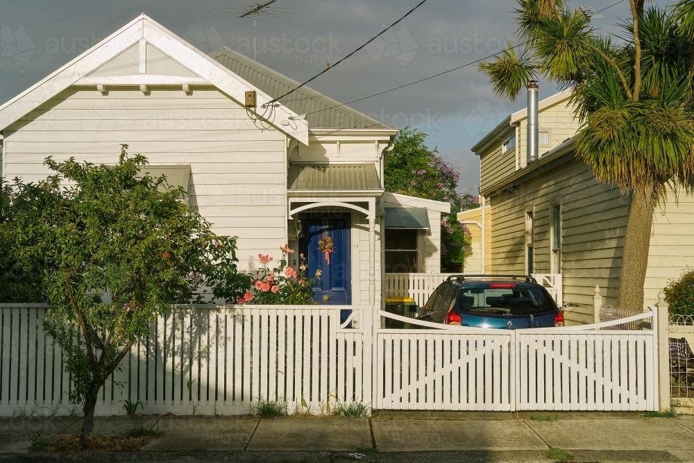 External street view of house with car in drive way - Australian Stock Image