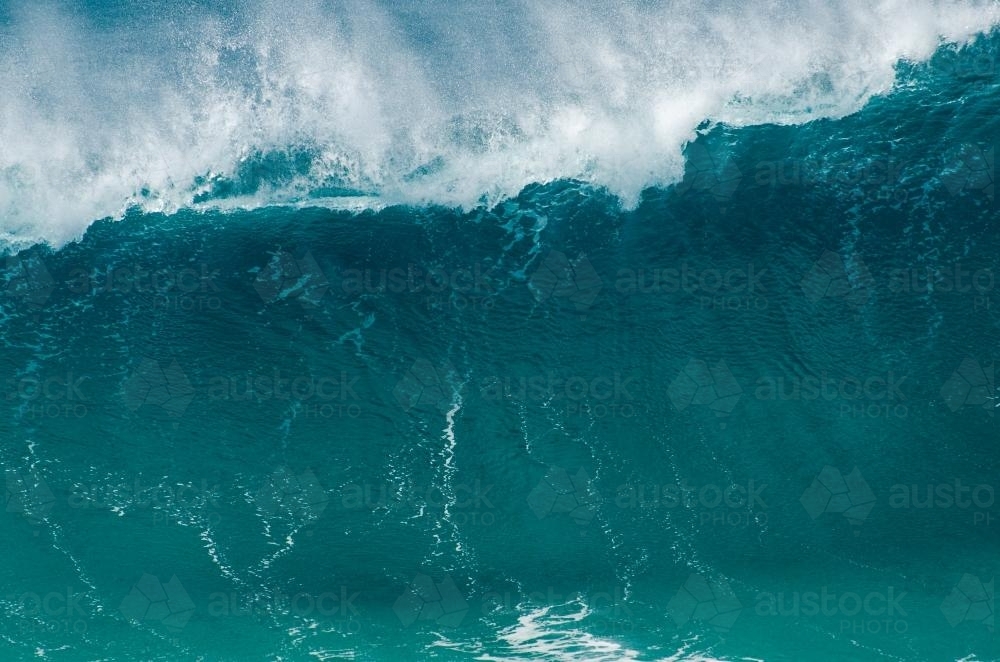 Face of a wave with wind whipping the foam off the top - Australian Stock Image