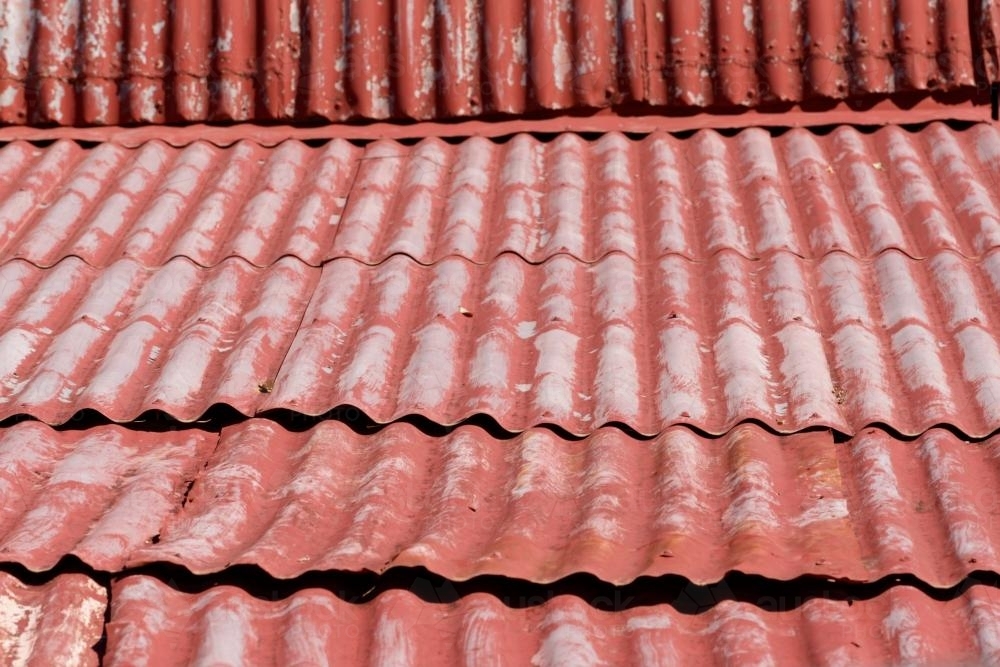 Faded red corrugated iron roof - Australian Stock Image
