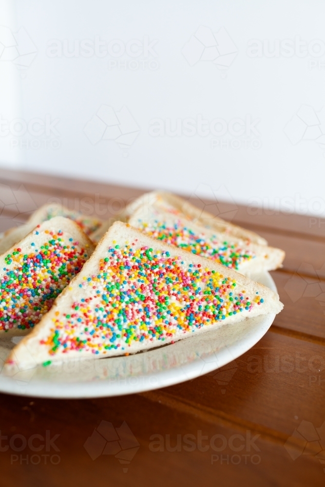 Fairy bread party food on wooden table - Australian Stock Image