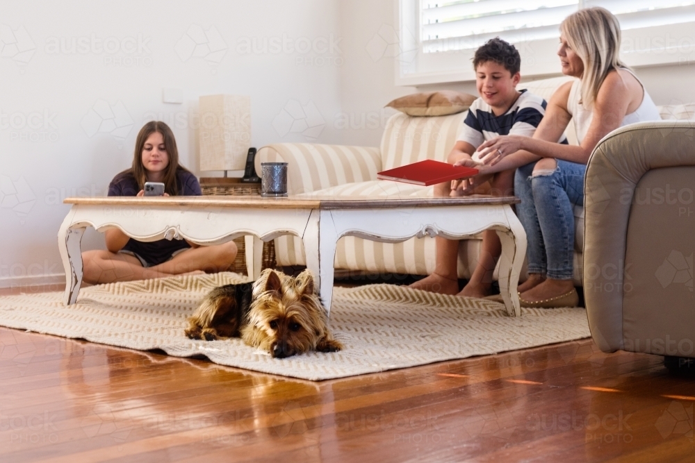 Image of family at home in living room - Austockphoto