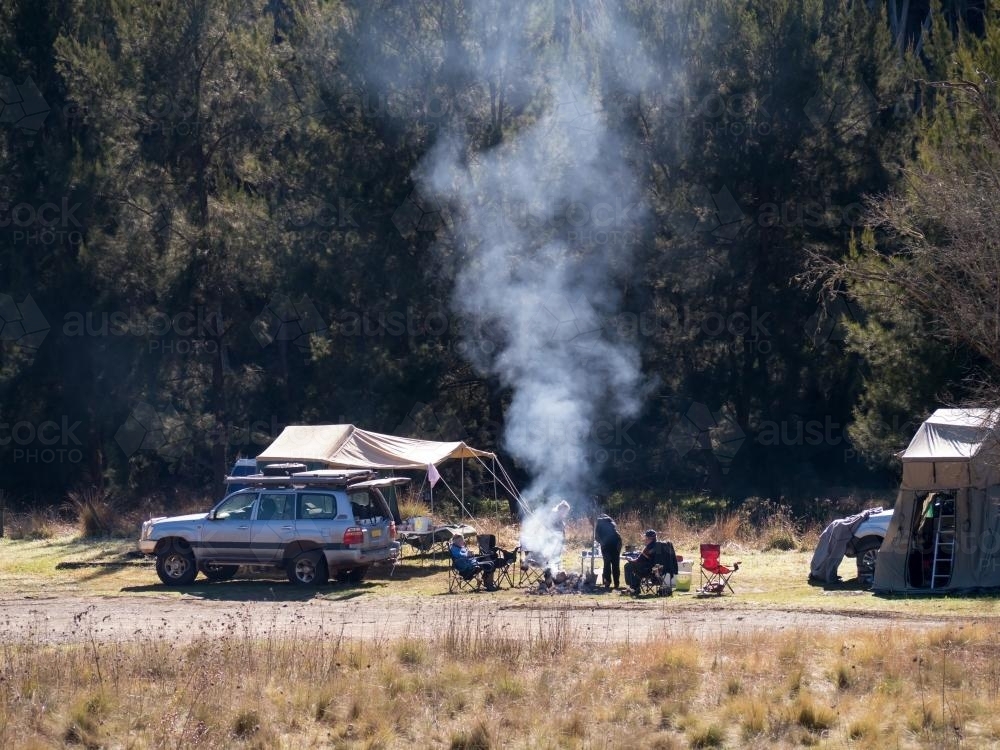 Family camping with fire, 4 wheel drive and tent - Australian Stock Image