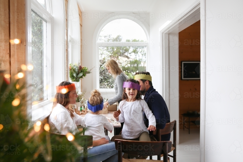 Family enjoying Christmas lunch wearing paper hats - Australian Stock Image