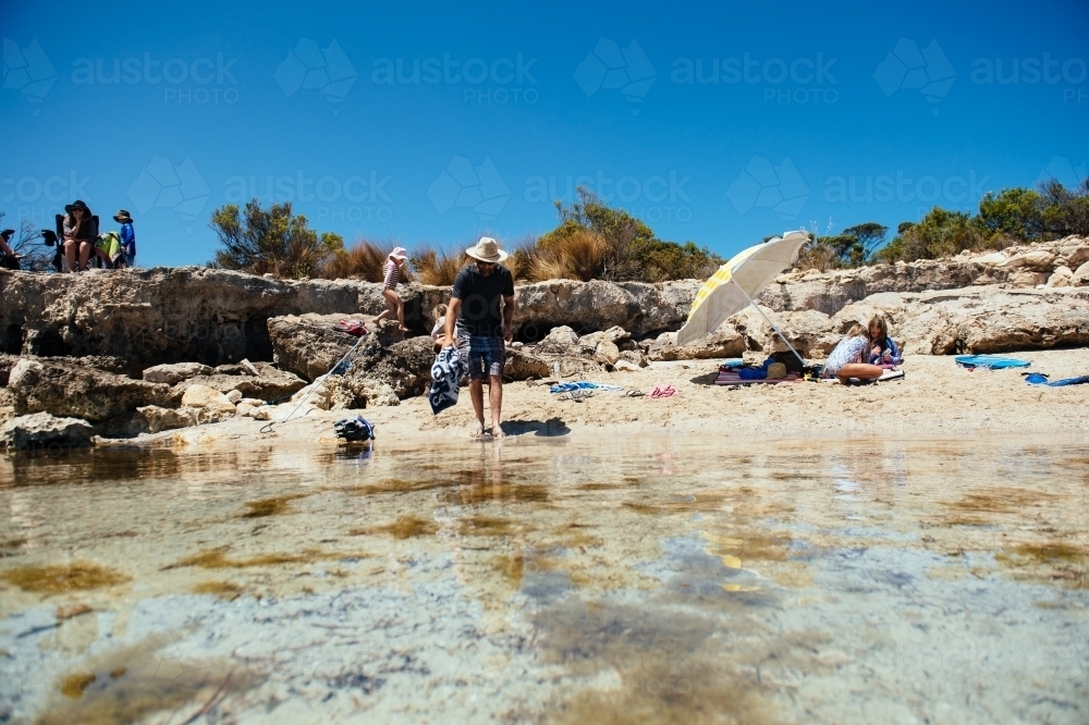 Family enjoying the beach at Blacksprings Overflow campground - Australian Stock Image