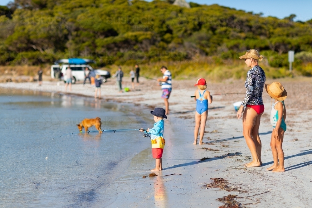 family enjoying themselves on the beach - Australian Stock Image