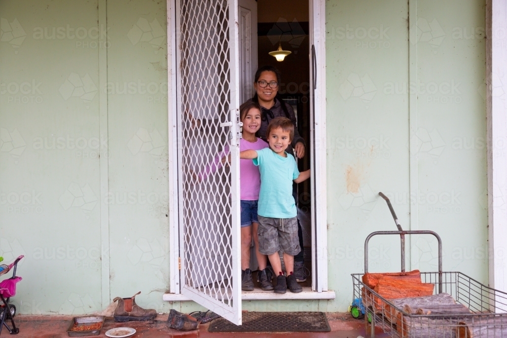 Family going out of front door of home - Australian Stock Image
