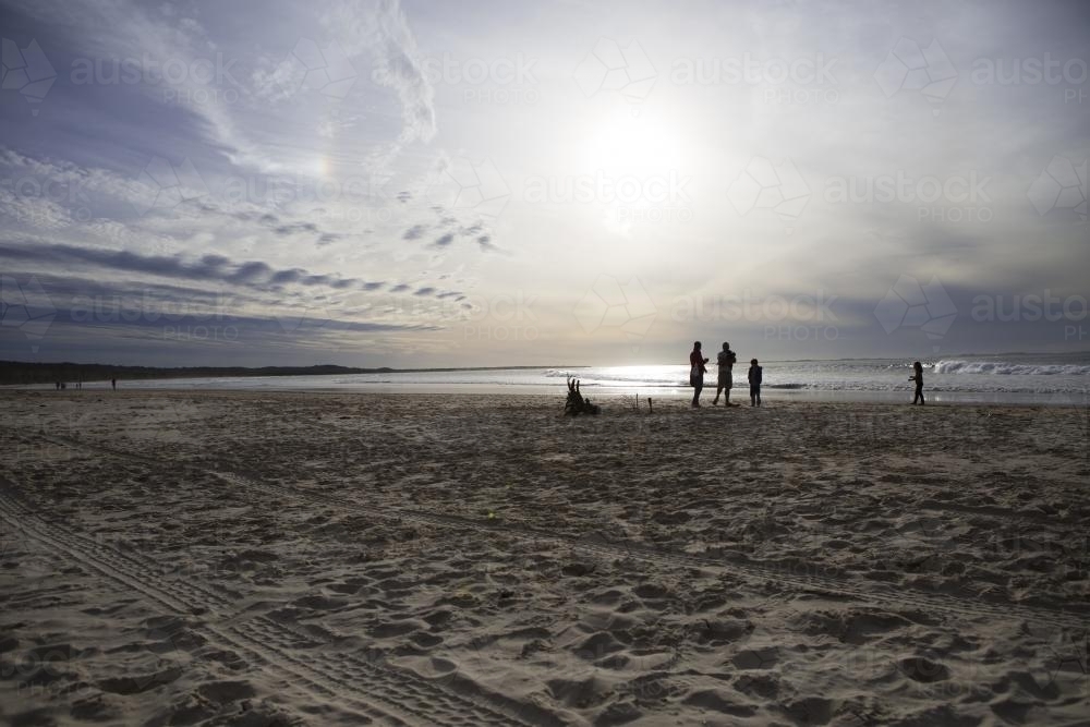 Family hanging out on the beach - Australian Stock Image
