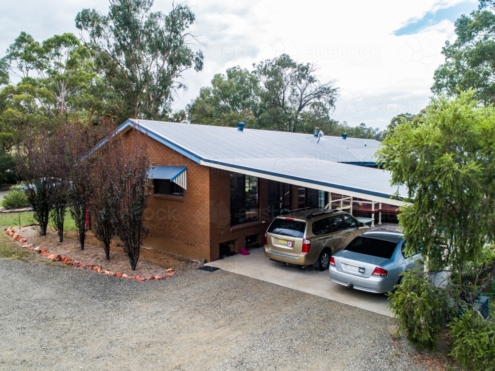 Family home with two cars parked in carport - Australian Stock Image
