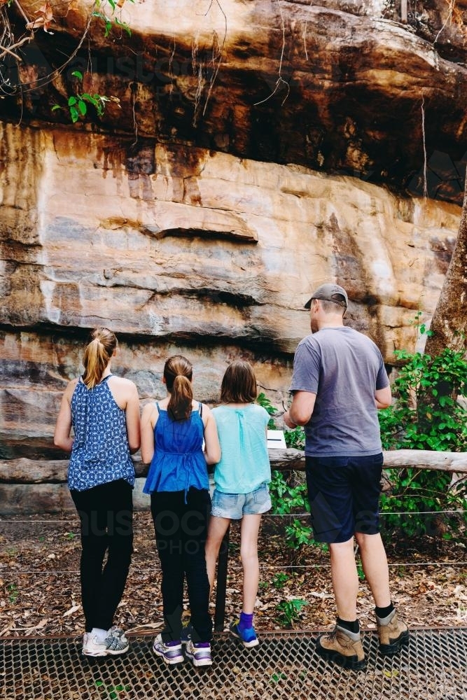 Family looking at cave art in regional NT - Australian Stock Image