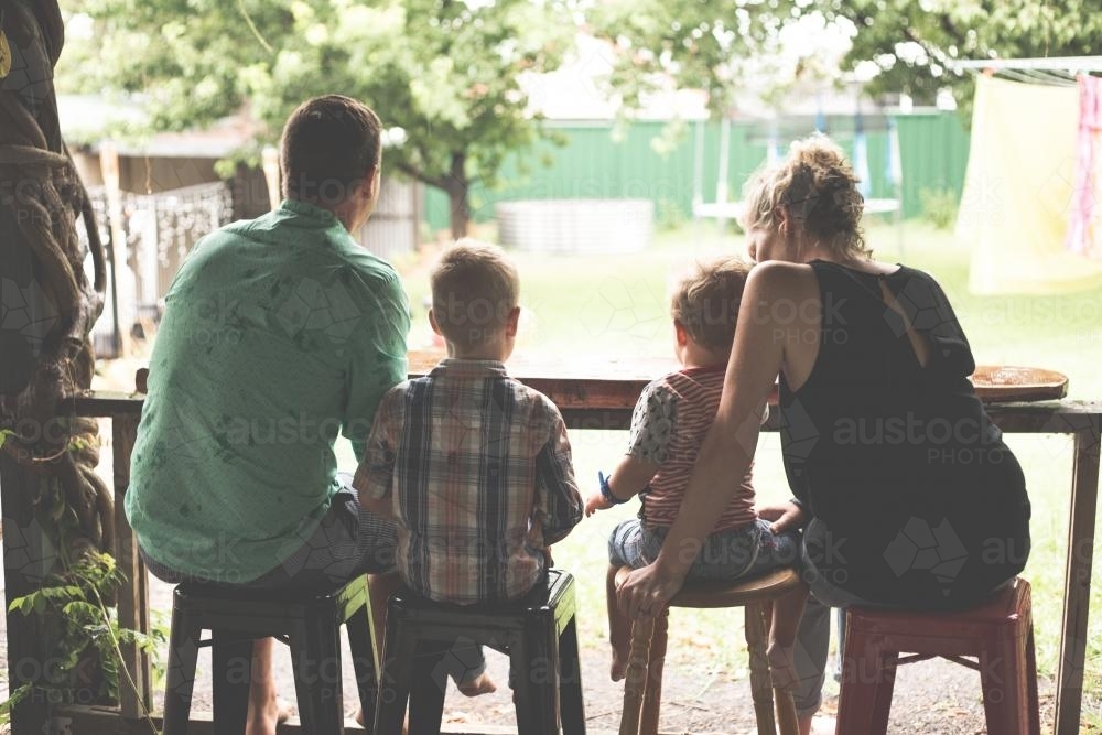 family looking out onto their backyard - Australian Stock Image