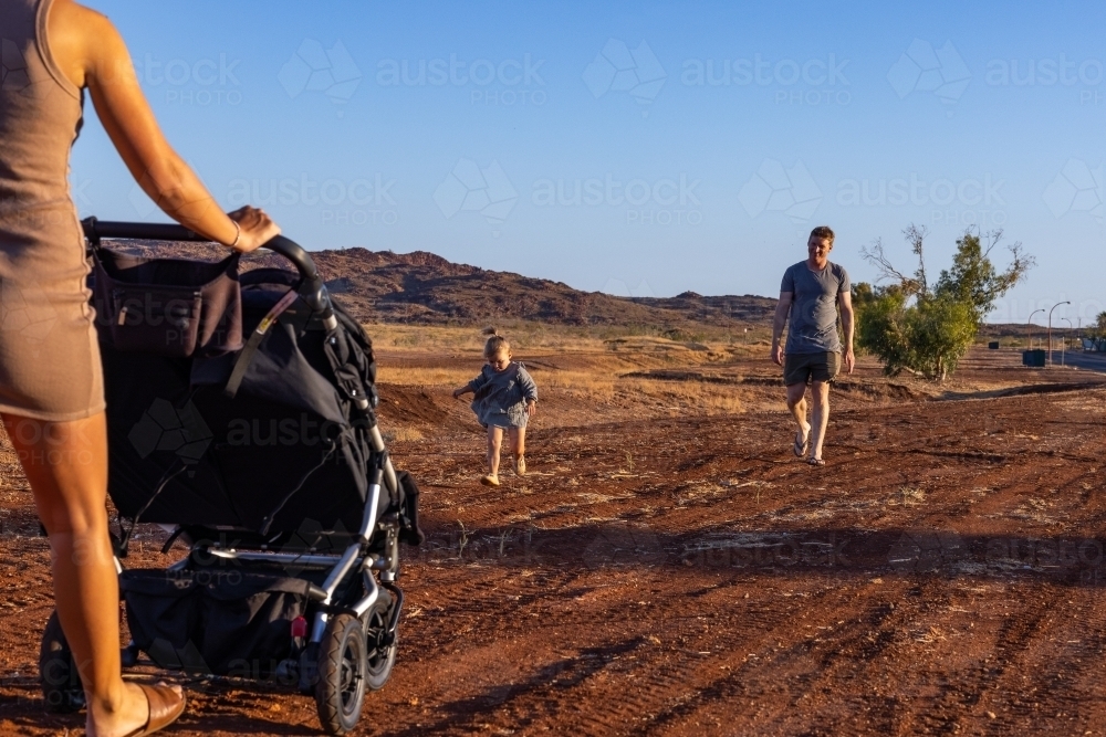 family out walking with pram in the Pilbara - Australian Stock Image