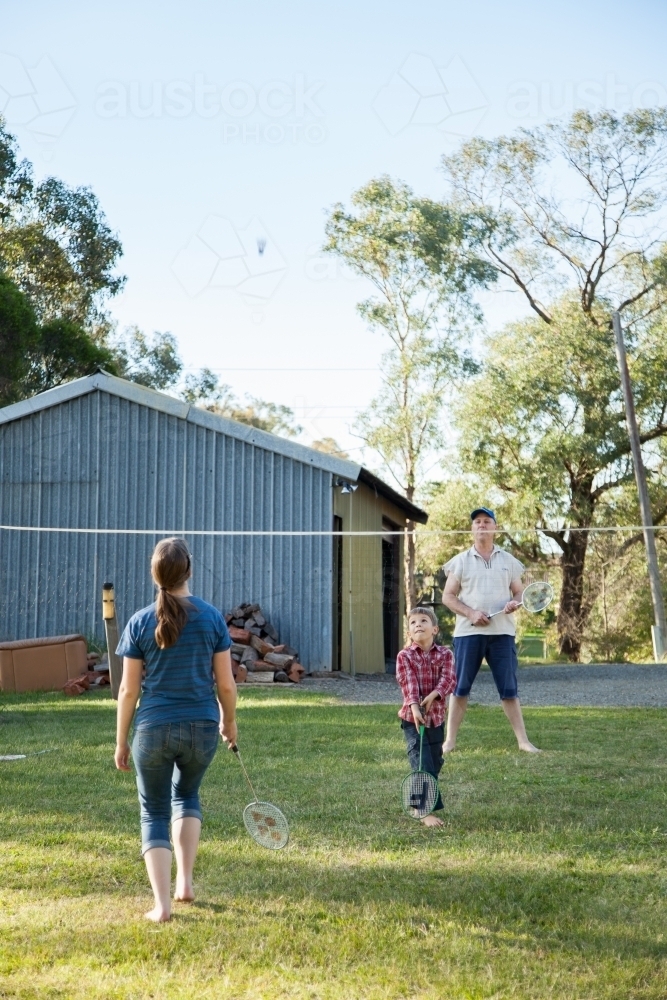Family playing badminton in the backyard - Australian Stock Image