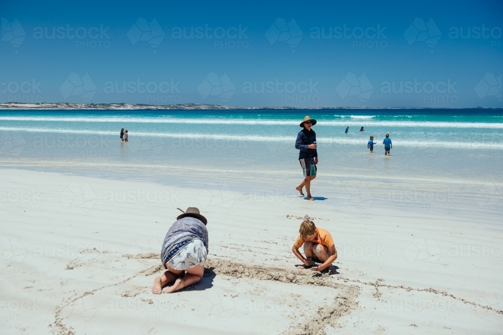 Family playing on Sensation Beach, Coffin Bay NP - Australian Stock Image