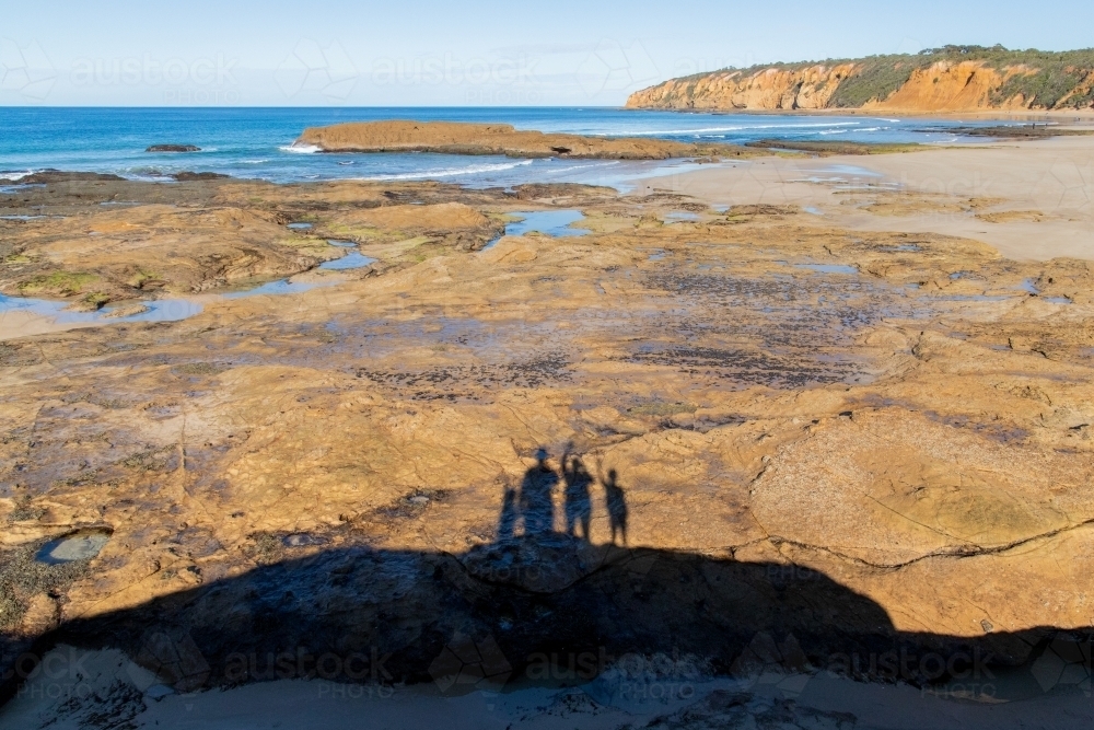 Family shadow over rockpool - Australian Stock Image